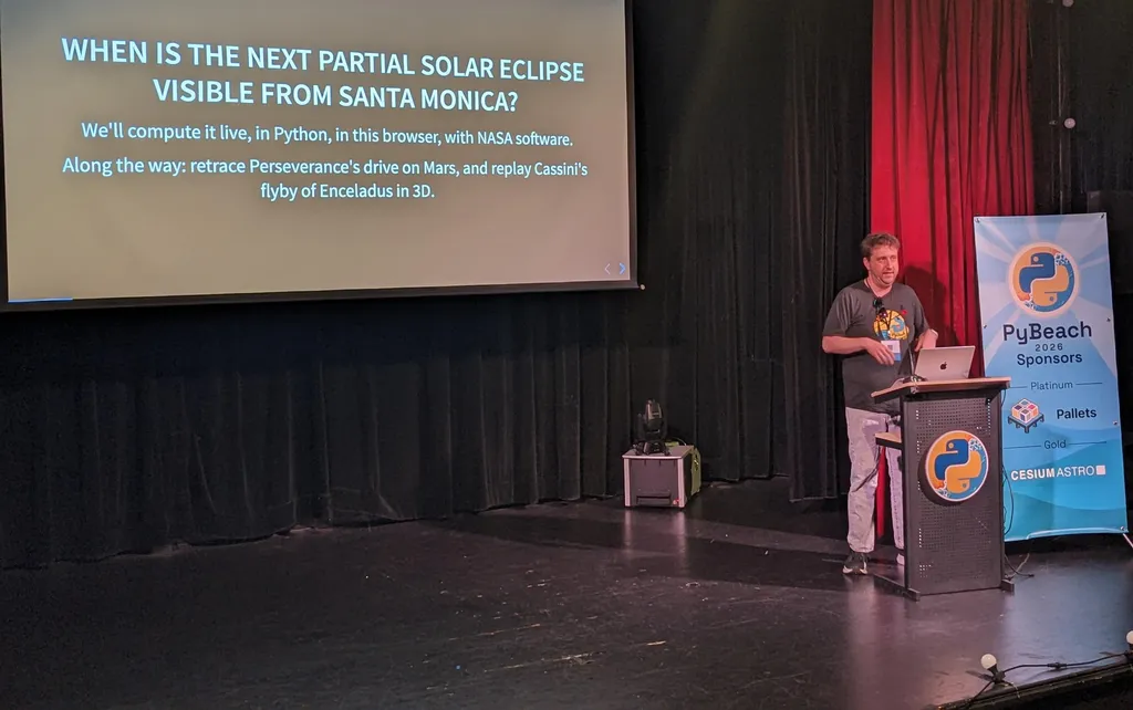 Andrew Annex on stage with the slide 'When is the next partial solar eclipse visible from Santa Monica?'