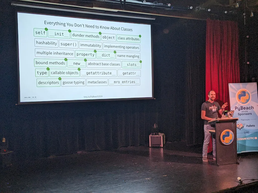 Trey Hunner on stage in front of a slide listing the class topics he would and would not cover