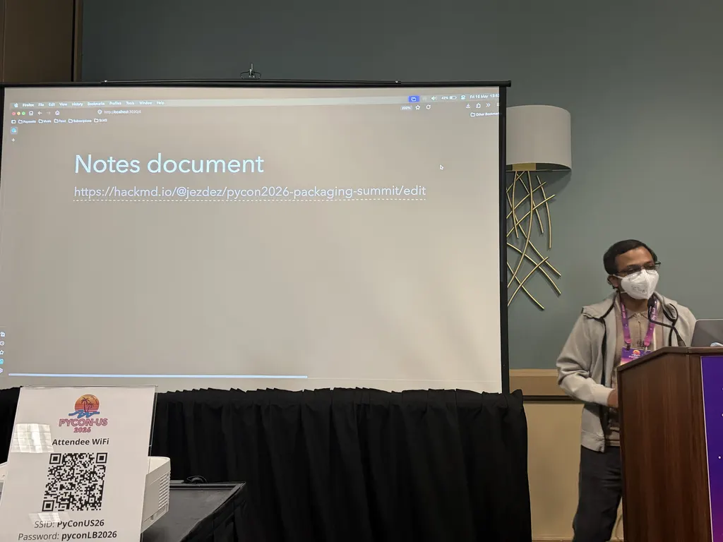 Pradyun Gedam at the podium opening the Packaging Summit with the shared HackMD notes URL on screen